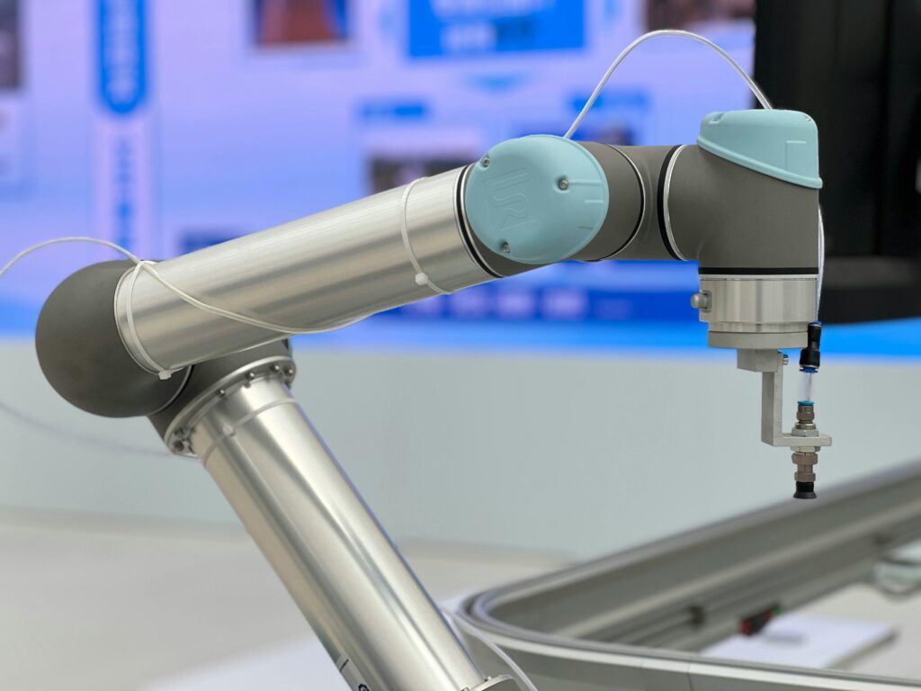 Detailed close-up of a modern industrial robotic arm in a manufacturing setting.